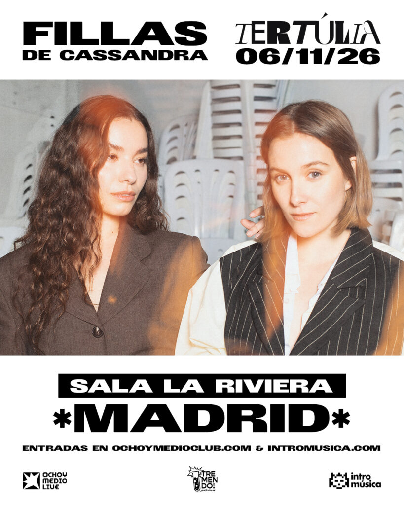 Event poster: two women in blazers foreground; bold text reads 'FILLAS DE CASSANDRA' and 'TERTULIA 06/11/26' with 'SALA LA RIVIERA MADRID' and ticket links at the bottom.