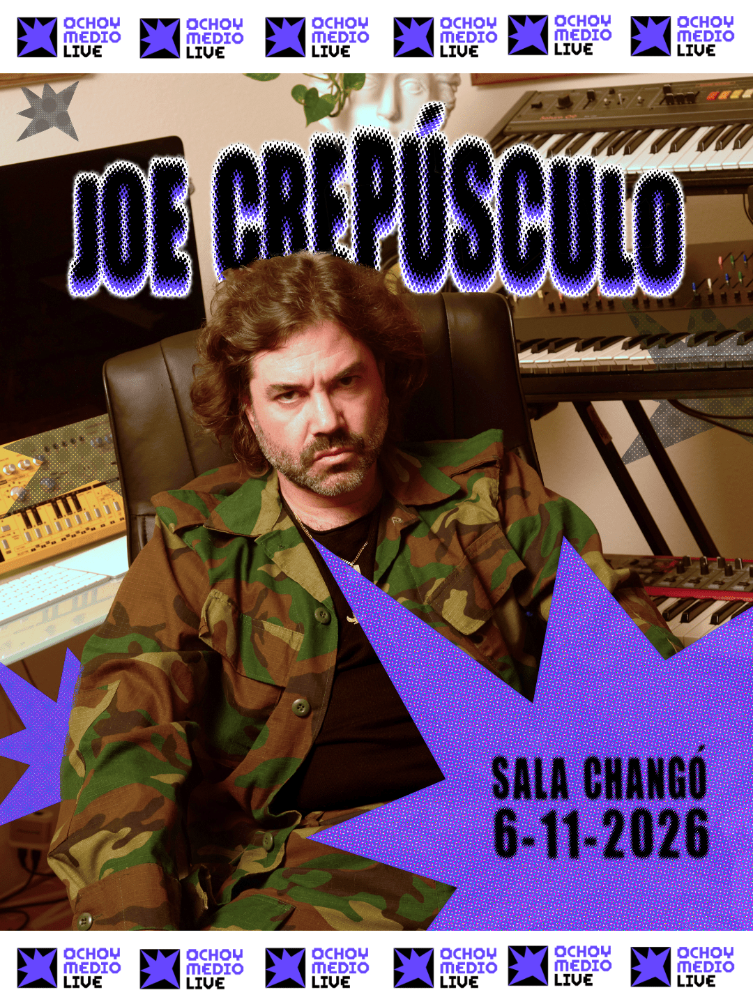 Man with shoulder-length hair and beard in camouflage jacket seated in a music studio with synths and keyboards; bold purple text and starburst graphics announce a concert, date 6-11-2026 at Sala Chango.