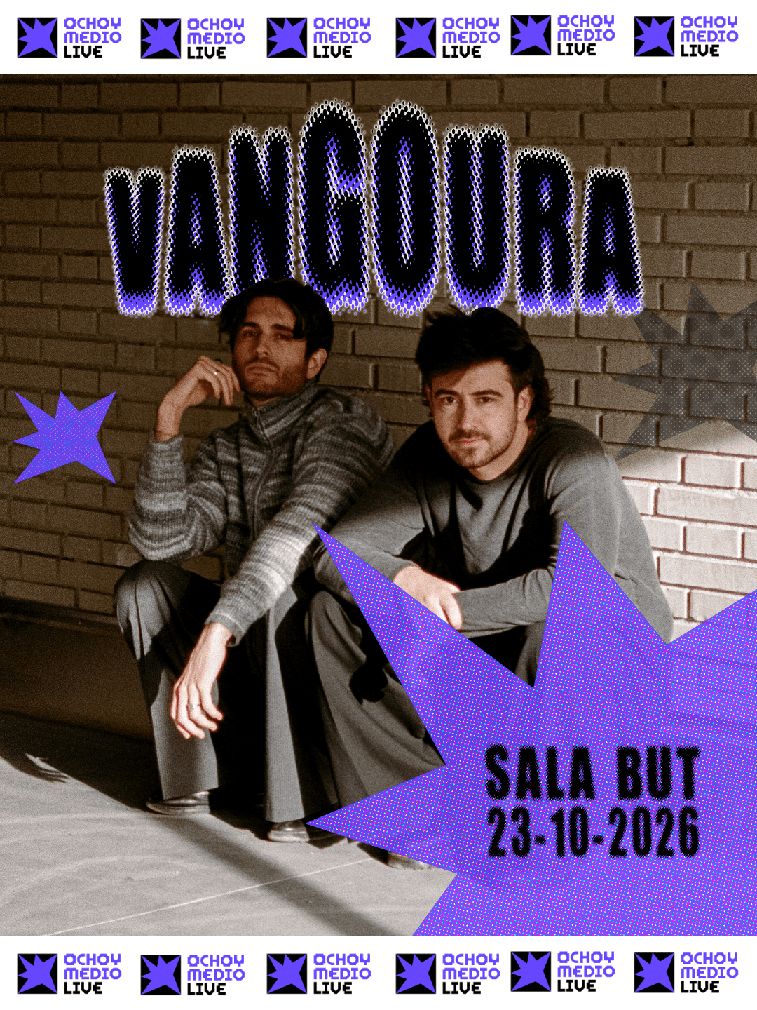 Two men sit against a brick wall on a promo poster for VANGUARD, with bold purple lettering, starbursts, and the date 23-10-2026, surrounded by OCHOY MEDIO LIVE logos.
